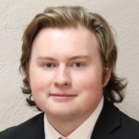 A professional headshot of Will Peltier